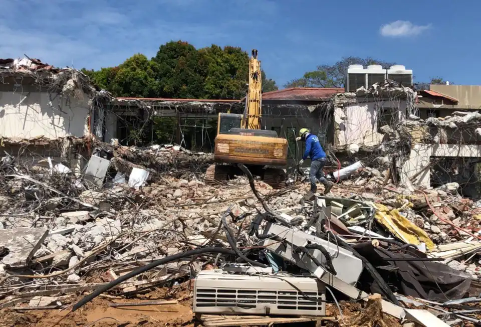 Demolition debris being cleared by a T.A.G. excavator
