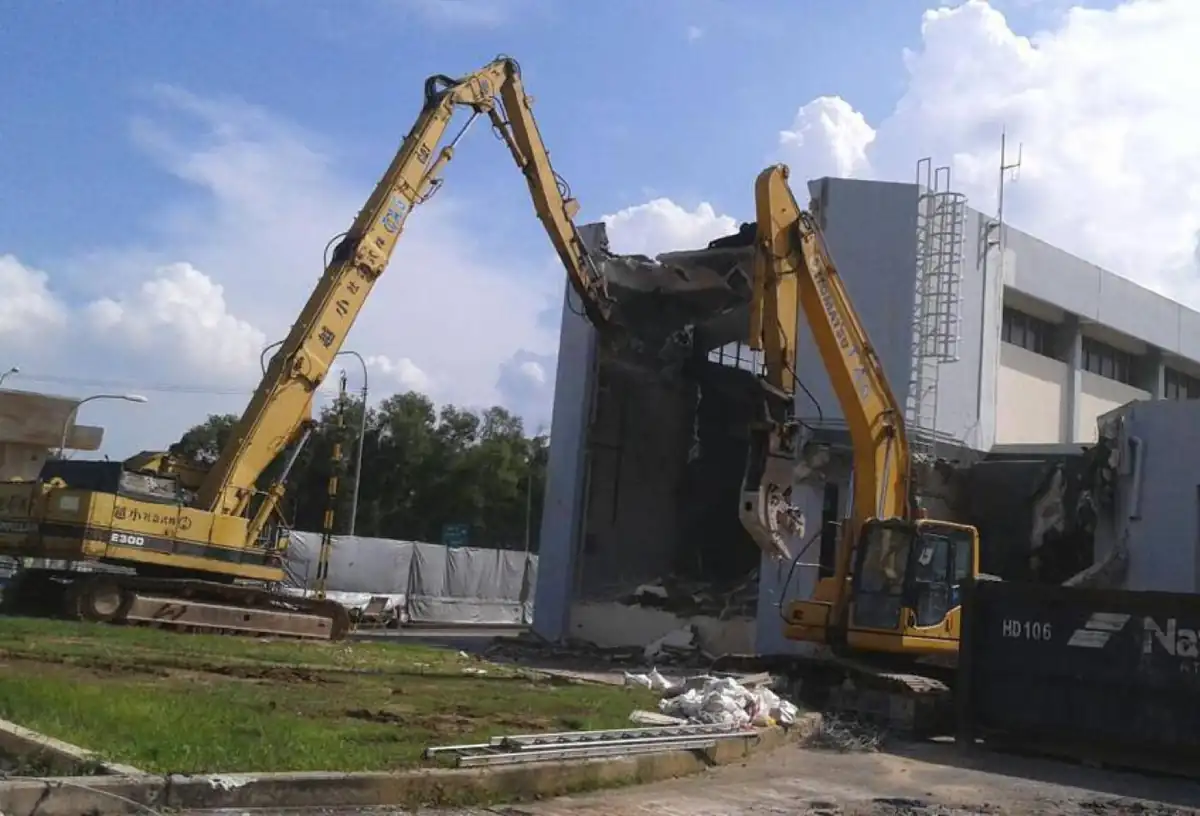 T.A.G. long-reach excavators demolishing an industrial building in Singapore